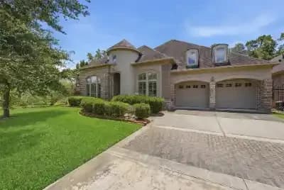 Front exterior of a two story brick home in Kingwood, Texas